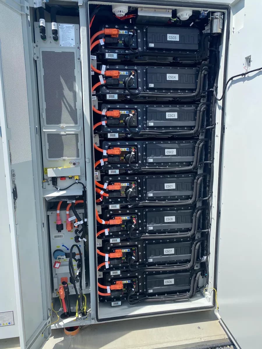 A battery rack inside an open cabinet.